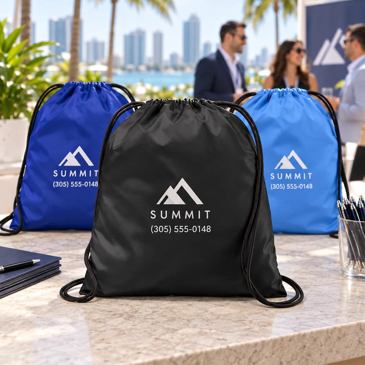 Custom cinch bags with business branding in black and blue