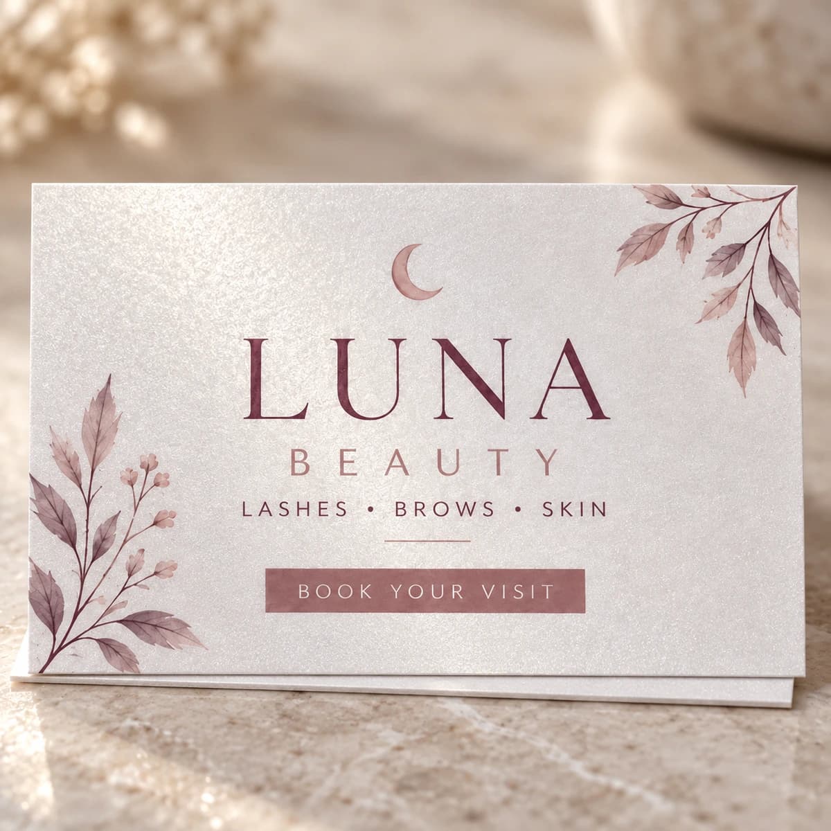 Close-up of 14pt pearl metallic paper with LUNA BEAUTY business branding