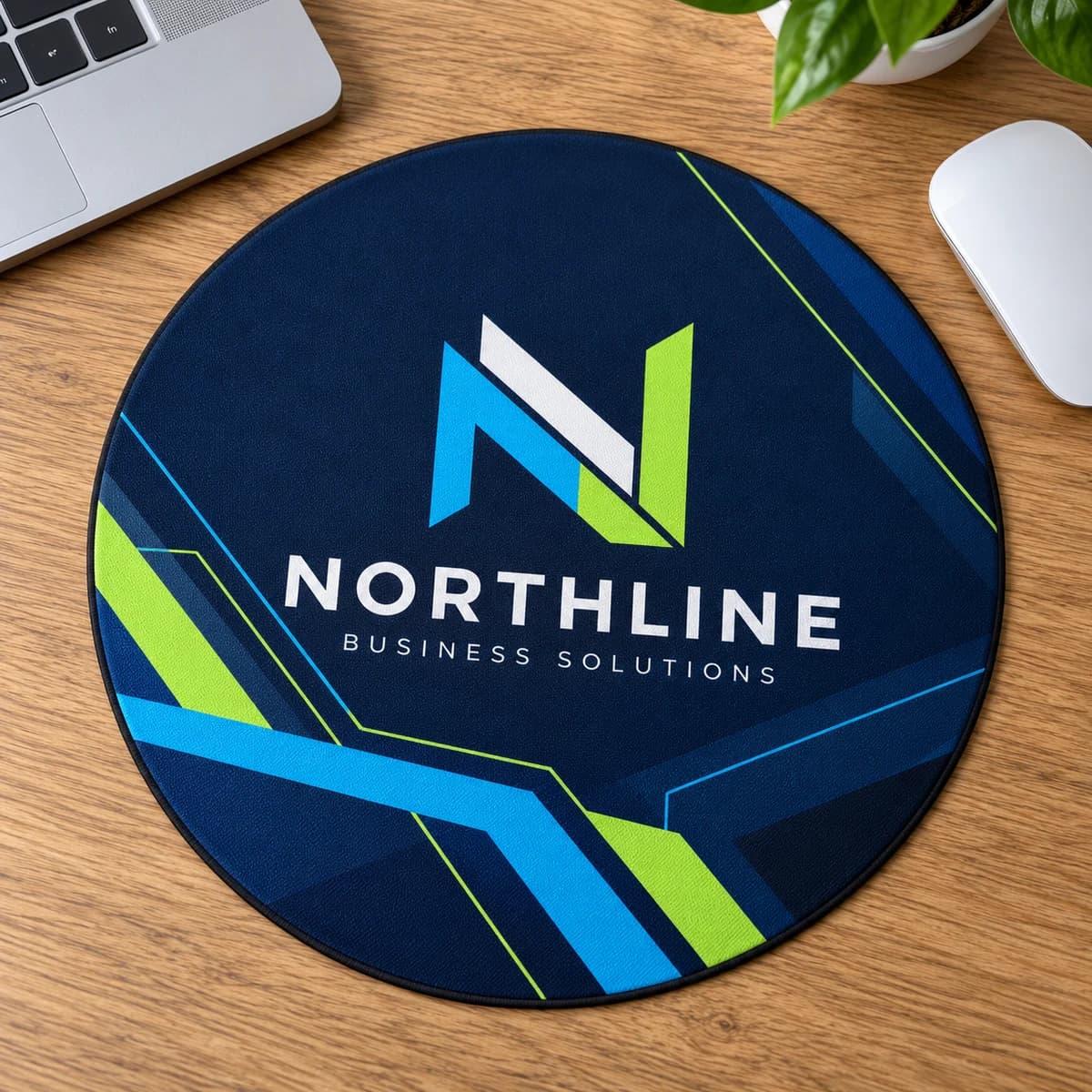 Round mouse pad with NORTHLINE corporate branding on an office desk